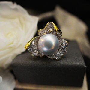 A beautiful fresh water grey pearl with micropaved zircon gold plated flower shape ring